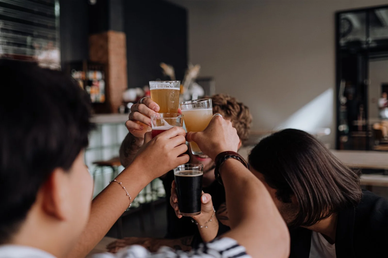 Friends raising glasses at a bar in the evening